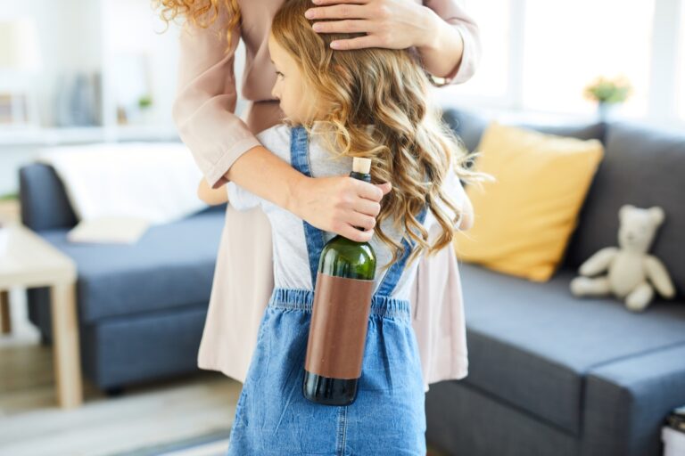 woman with alcohol addiction hugging daughter
